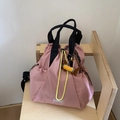 Detail of pink waterproof nylon drawstring backpack with yellow cord and dog plush charm - Pink (with Pendant)