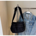 Detail of black canvas messenger bag with dual zipper pockets and adjustable wide strap - Black