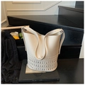 Chic cream white leather bucket bag featuring laser-cut hollow patterns and a shoulder strap - White