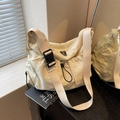 Creamy white nylon crossbody bag featuring wide fabric strap and large black buckle - Off-white