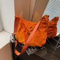 Vibrant orange nylon crossbody bag with drawstring pocket and wide adjustable strap - Orange