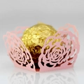 Detail of pink laser-cut rose hollow paper wrapper for wedding candy and truffles - Pink