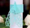 Detail of light blue laser-cut paper napkin ring featuring an elegant peacock design - Tiffany Blue