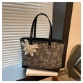 Gray floral jacquard tote bag with black leather trim and decorative flower charm - Black