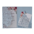 Close-up of laser-cut light blue rose patterns on elegant wedding invitation cards - Fog Blue
