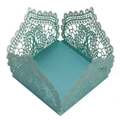Macro detail of laser-cut light blue candy box with intricate floral lace texture - Tiffany Blue