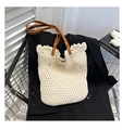 Detail of beige crochet tote bag with brown leather handles on a black blazer - One Size / White