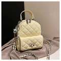 Mini quilted backpack in cream yellow featuring glossy finish and silver chain strap - With Charm Style / Yellow