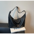 Close-up of black lychee grain leather hobo bag with adjustable wide strap and metal buckle - Black