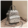 Silver quilted mini backpack featuring metallic finish and woven chain strap - With Charm Style / Silver
