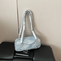 Light blue denim texture cylinder shoulder bag with silver padded strap and ball charm - Blue