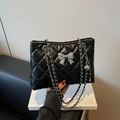Quilted black chain crossbody bag featuring a silver bow and metal ball charm - Black