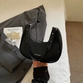 Black pebbled leather crescent hobo bag with white brand logo and silver metal zipper - Black