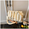 Chic cream pleated cloud bag with a braided handle and adjustable crossbody strap - Yellow