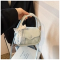 Detail of mint blue square handbag with white lace bow and elegant gold metal hardware - Green