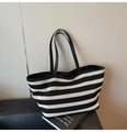 Detail of black and white striped woven tote bag with premium leather shoulder straps - Black