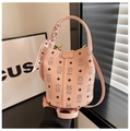 Detail of pink bucket bag featuring teddy bear monogram and decorative silk scarf handle - Pink