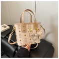 Detail of beige crossbody bag featuring bear print and gold-tone brand plate logo - Off-white