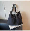 Détail du sac cabas noir à cordon avec doubles poches avant sur un support de livre blanc - Noir
