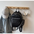 Detail of black lychee grain leather backpack with silver zippers and wide patterned strap - Black