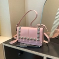 Pink moto-style crossbody bag with silver dome studs and adjustable shoulder strap - Pink