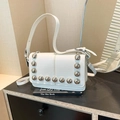 Chic white leather crossbody bag featuring silver metal studs and adjustable shoulder strap - White