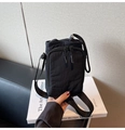 Vue détaillée d'un sac seau noir en nylon avec fermeture éclair frontale et cordon serrage - Noir