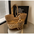Detail of hand-woven straw tote with wave patterns and evil eye tassel pendant - Khaki Large