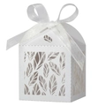 Detail of white laser-cut leaf patterns on wedding favor box with a silk ribbon bow - White