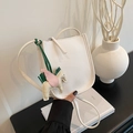 White litchi pattern leather saddle bag featuring a colorful Pegasus horse charm - White