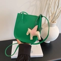 Green lychee pattern saddle bag with a decorative leather pegasus charm accessory - Green