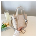 Detail view of beige crocodile pattern bucket bag with silver heart charm and chain link - With Charm / Khaki