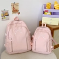 Détail de sacs à dos en toile rose en tailles L et S avec broderie de nœuds blancs élégants - Grand / Rose
