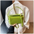 Detail of bright green pebble leather handbag with pearl lace charm and top handle - Light Green With Charm / Light Green