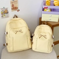Comparaison de taille entre grand et petit sac à dos en toile crème avec broderie nœud - Grand / Jaune