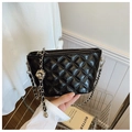 Detail of black quilted leather bucket bag with silver chain strap and metal ball - Black