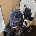 Blue denim star pattern backpack with brown leather straps and front zipper pocket - Blue