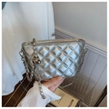 Detail of silver quilted chain bag with metallic finish and woven shoulder strap - Silver