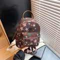 Mini backpack in dark brown woven canvas with vibrant multi-color star patterns and leather handle - Brown