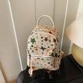 Cream canvas mini backpack with colorful star patterns and a leather handle - White