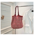 Detail of red and white striped knit tote with adjustable leather strap and silver buckles - Red with Pendant
