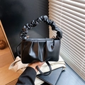 Detail view of the black pleated cloud bag with elegant ruched handle and PU leather texture - Black without Pendant