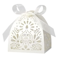 Close-up of white laser-cut wedding candy box with intricate heart pattern and satin bow - Ivory