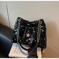 Detail of black quilted shoulder bag with silver star decor and metal chain strap - Black