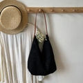Large black hollow knit tote bag with brown leather shoulder straps for beach vacation - Black