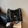 Glossy black quilted bucket bag with star diamond detail and chain strap - Black