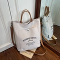 Große beige Canvas-Tragetasche mit braunen Webgriffen und verstellbarem Schultergurt - Beigegrau
