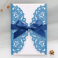 Detail of blue glitter laser-cut invitation with navy ribbon and premium white insert - Sapphire Blue