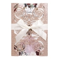 Detail of rose gold glitter wedding invitation with laser-cut floral pattern and satin bow - Glitter Champagne Gold