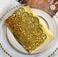 Close-up of laser-cut gold hollow card with floral patterns on marble surface - Reflective Gold